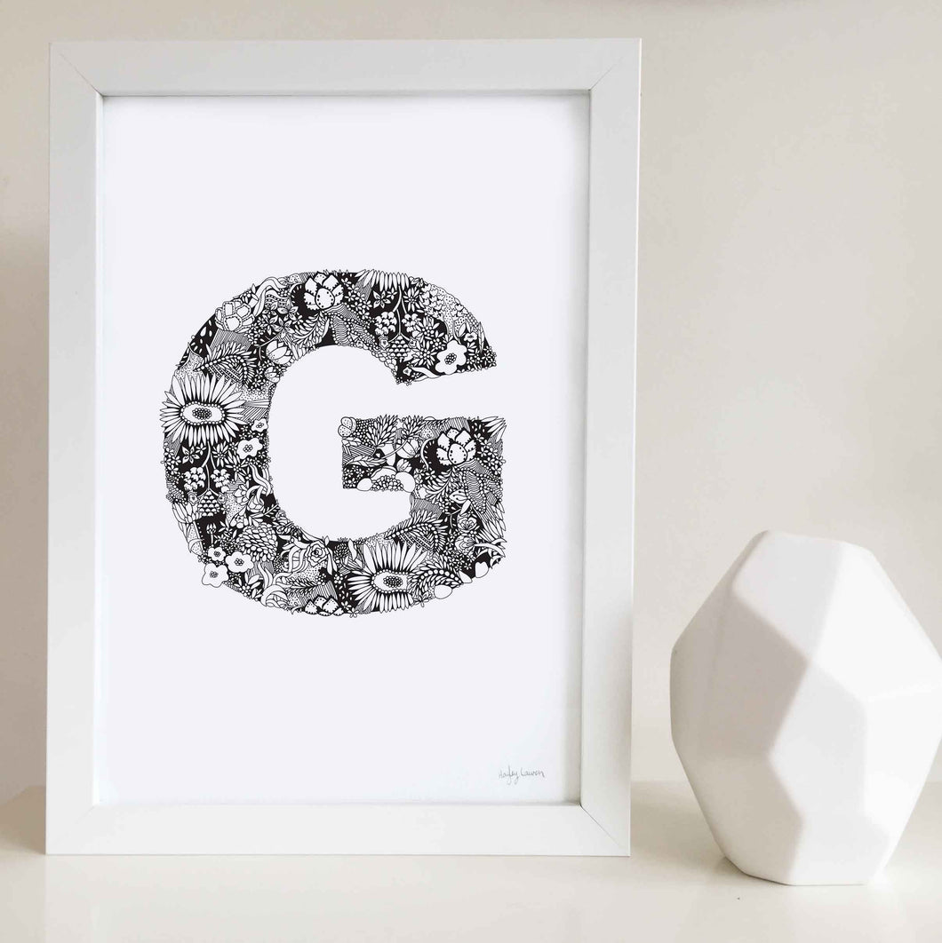 The floral letter 'G' artwork was illustrated by Hayley Lauren in Melbourne, Australia. It is the perfect artwork to personalise a nursery or kids bedroom.