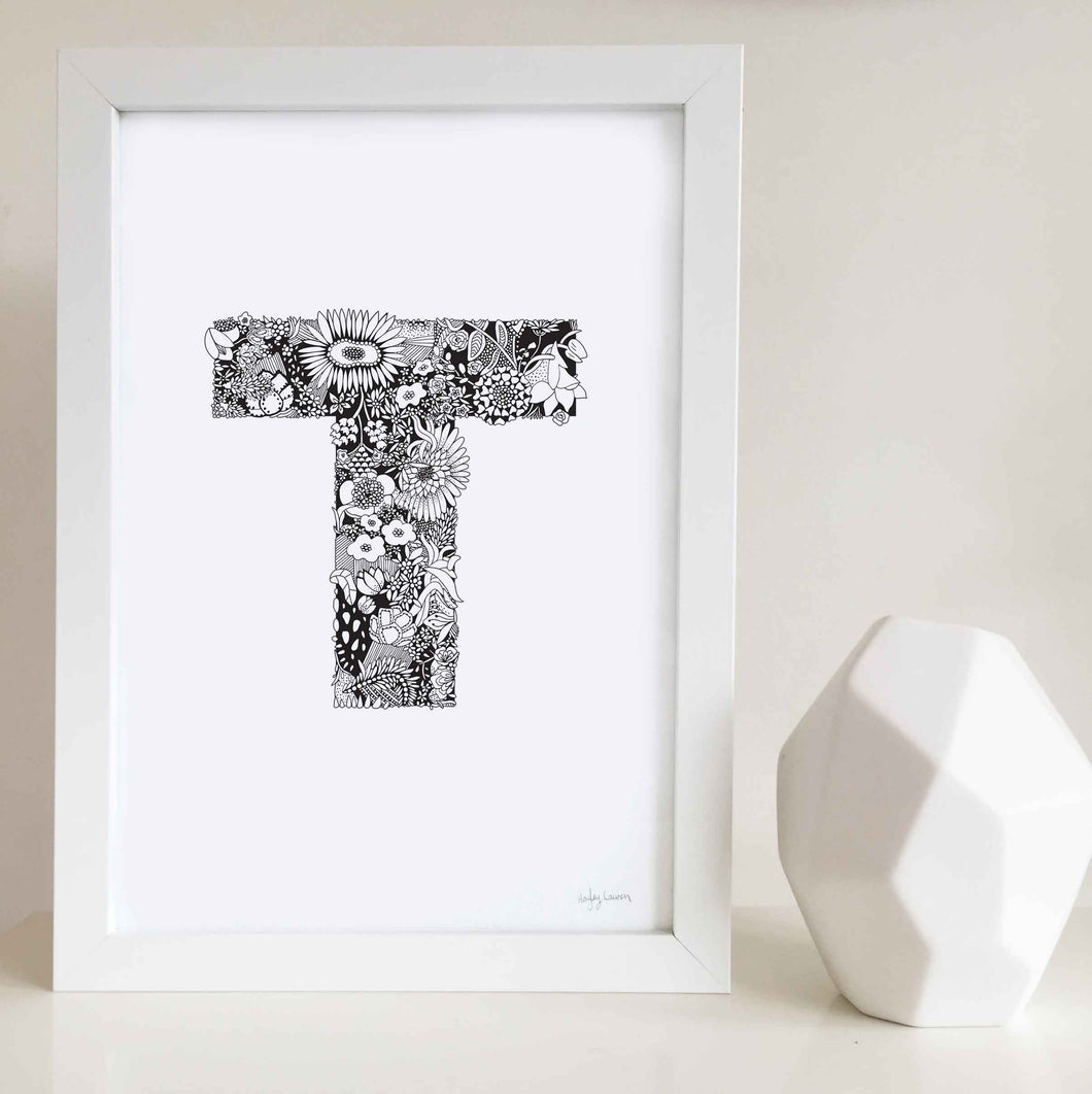 The floral letter 'T' artwork was illustrated by Hayley Lauren in Melbourne, Australia. It is the perfect artwork to personalise a nursery or kids bedroom.